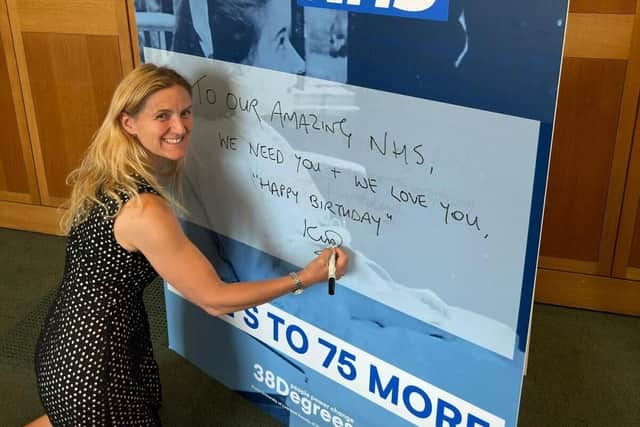 MP Kim Leadbeater Signing Drywipe NHS card to celebrate 75th birthday